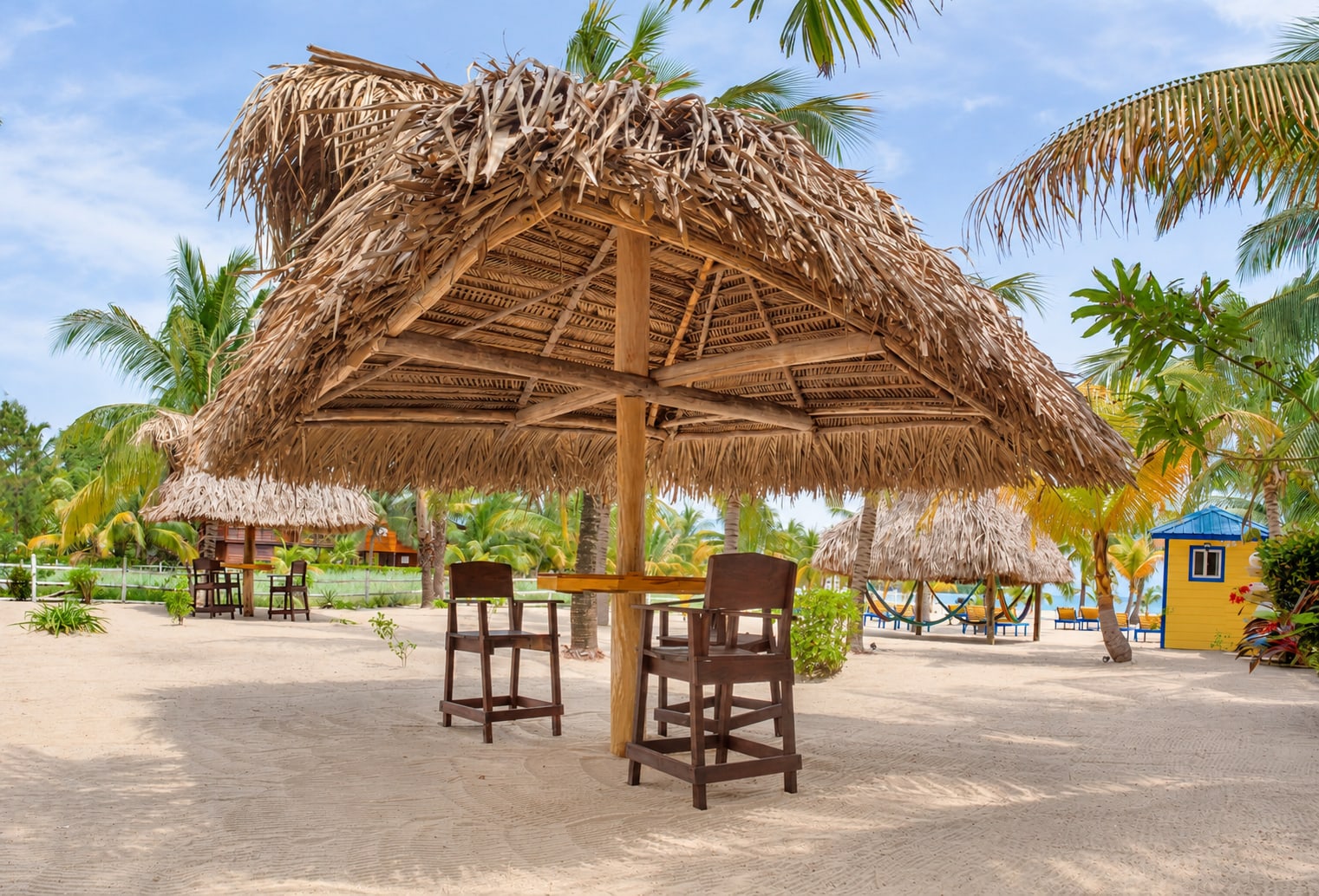 Shaded palapa and seating at Casa Palma’s beachfront property